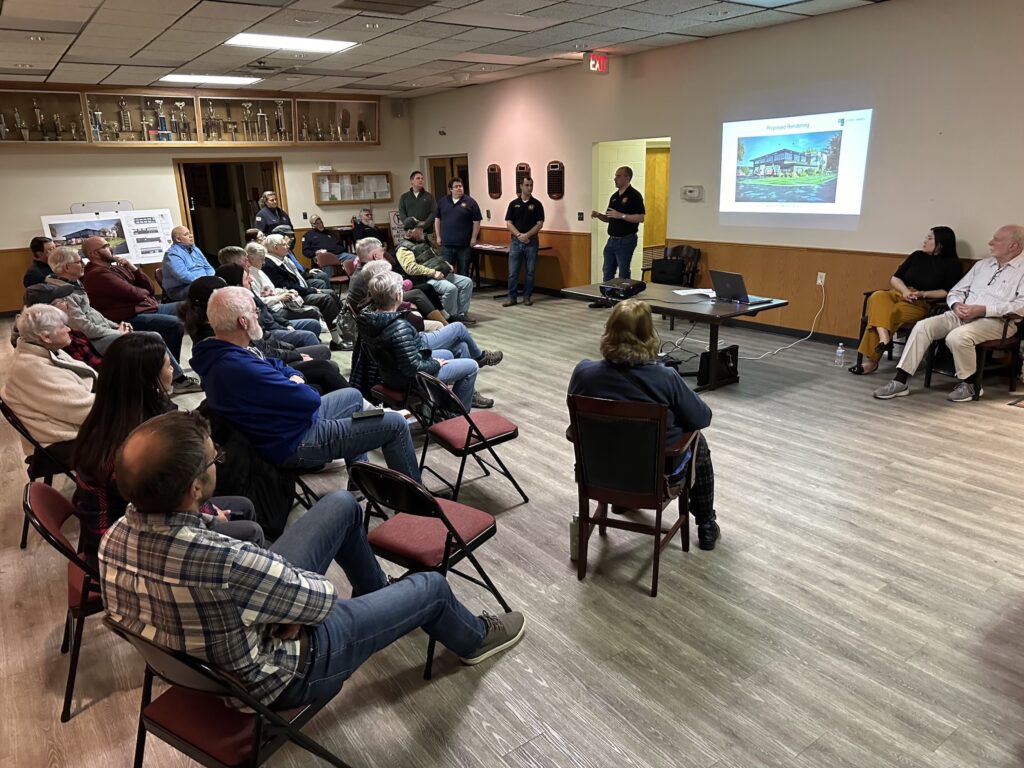 Residents meeting for a public meeting of the proposed new firehouse.